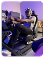 Student wearing sensors and driving a car simulator